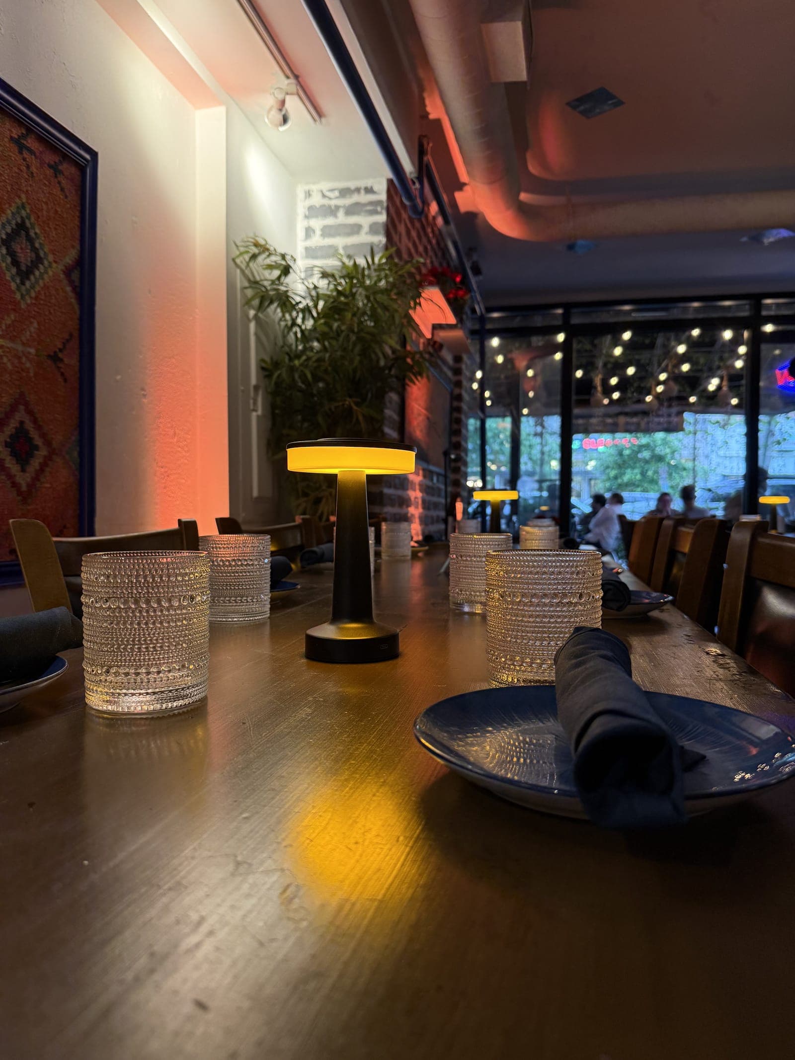 A candlelit communal table at Sofra Woodley Park
